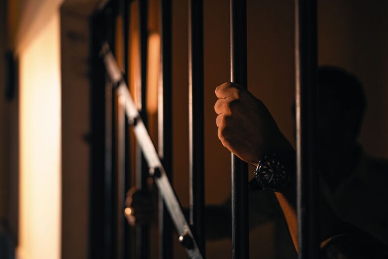 dramatic shadow casting through jail bars